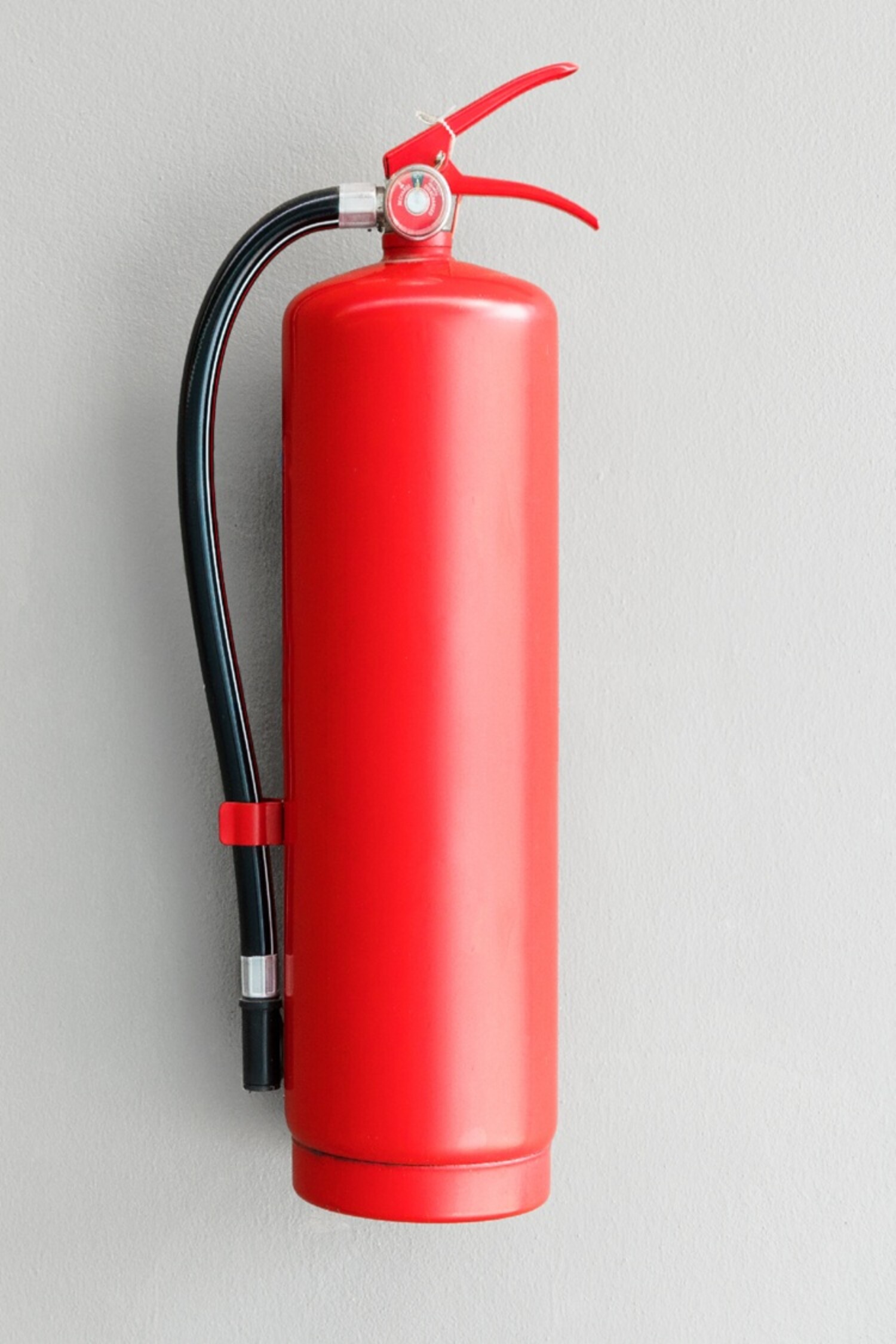 Fire extinguisher on the gray wall